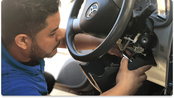 Technician installing or removing a Smart Start ignition interlock device from a vehicle