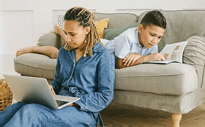 Mother and son looking at a laptop together on a couch