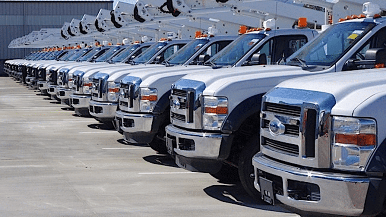 Fleet of commercial utility trucks parked in a row